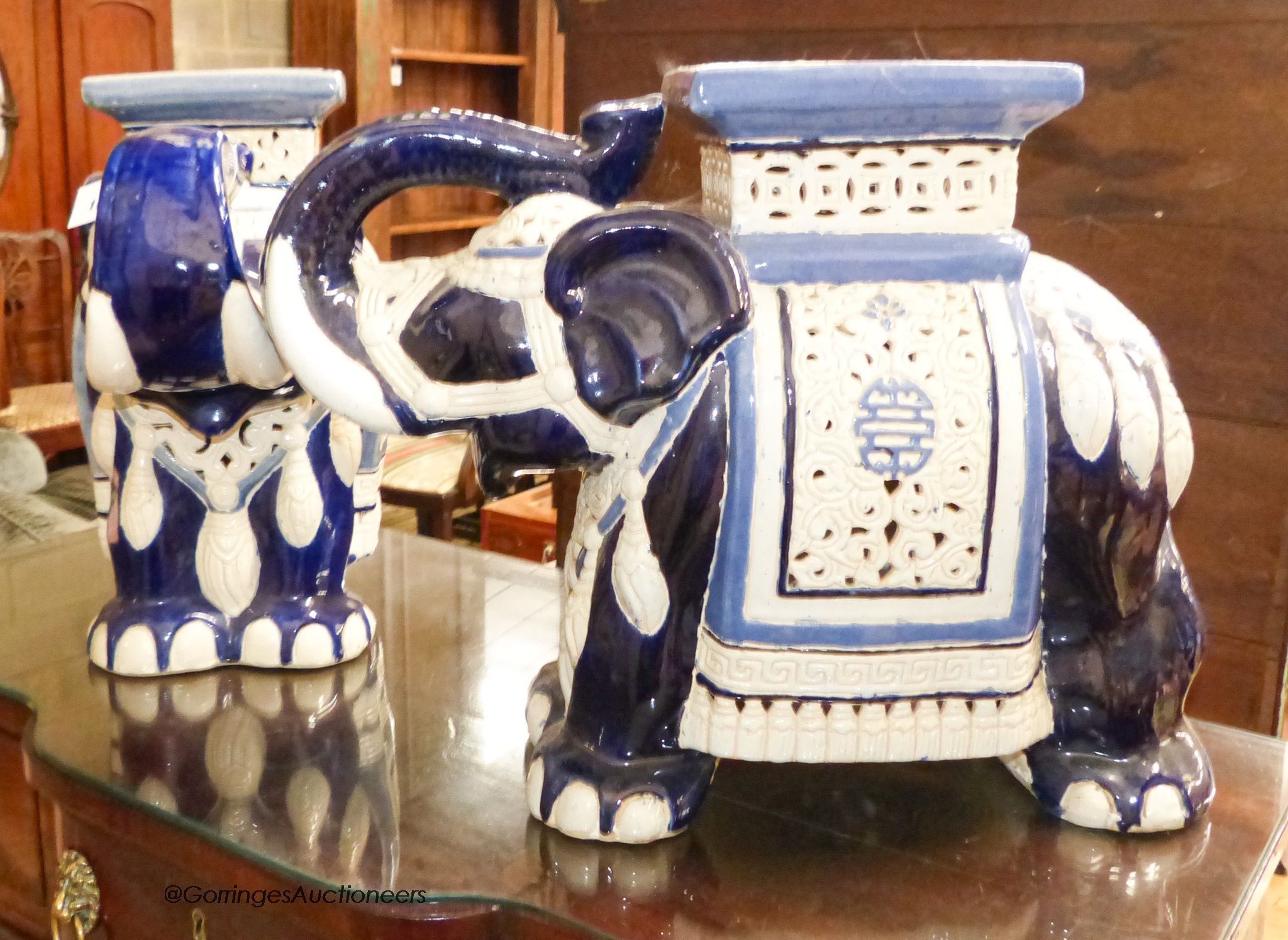 A pair of Chinese glazed earthenware elephant seats, width 60cm, height 43cm